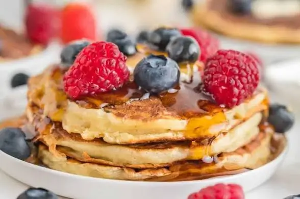 Pancakes topped with blueberries and raspberries